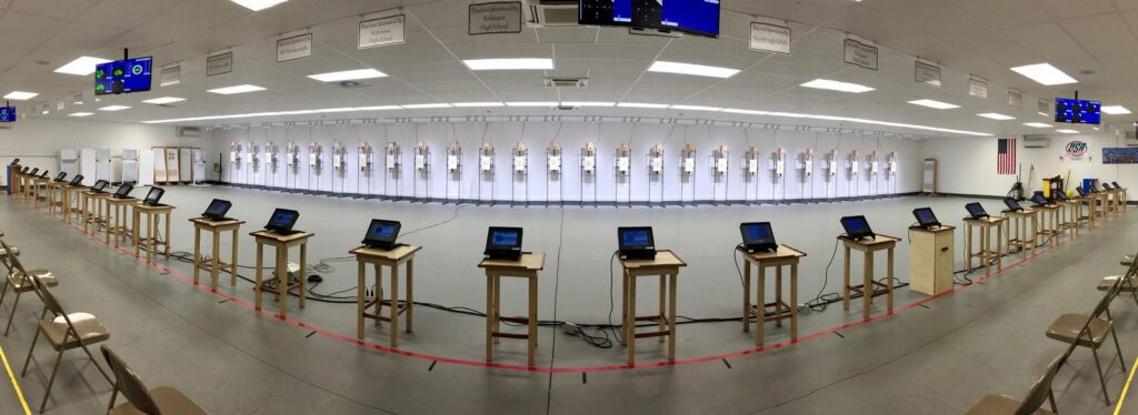 Panoramic view of the indoor Sills Air Range: a long row of shooting stations facing the target line